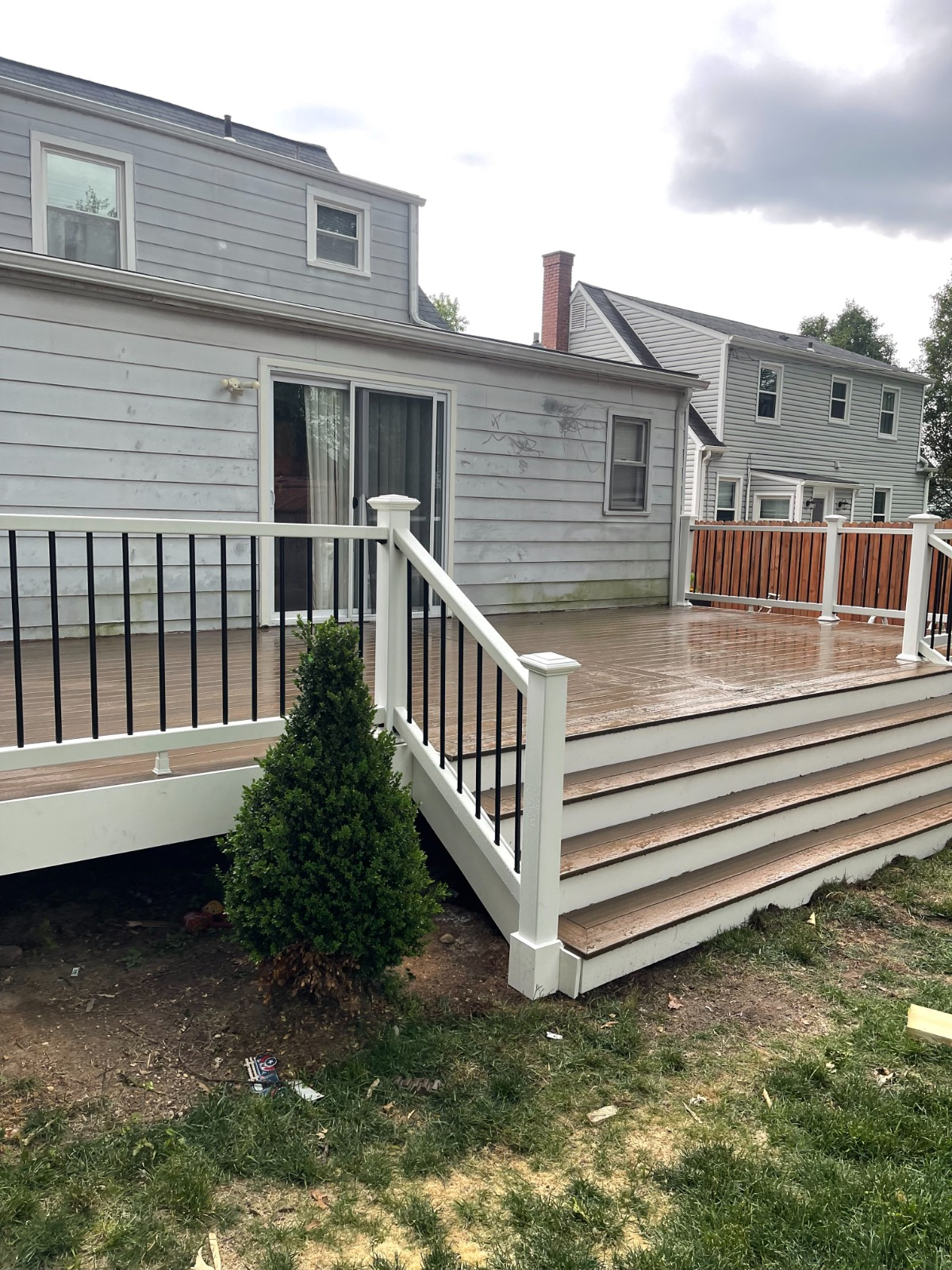 New composite deck build with white railings and black balusters