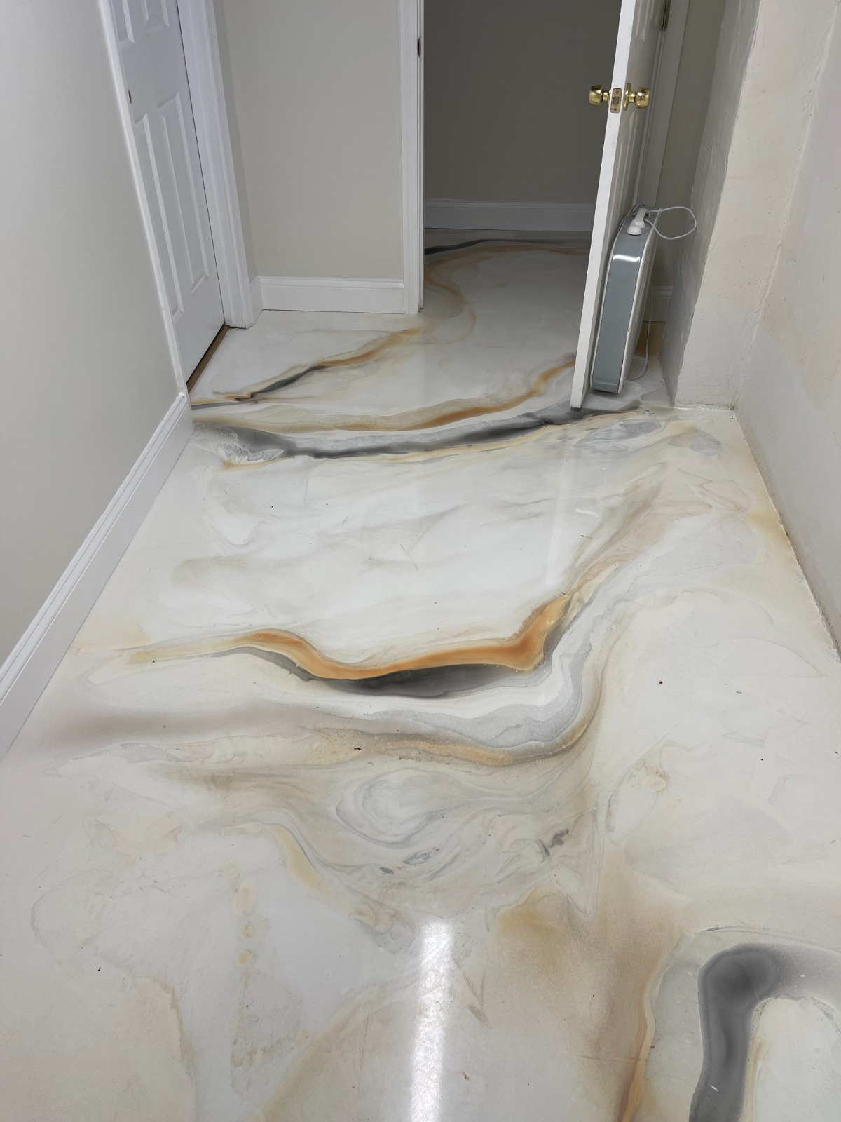 Metallic epoxy hallway floor with marbled white, grey, and copper swirls