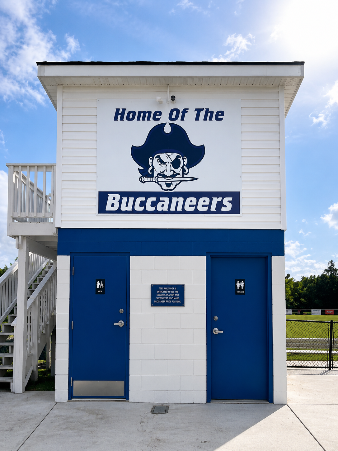 Exterior remodel of a community field house with fresh siding and paint